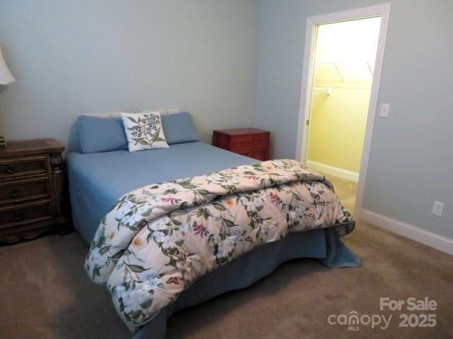 bedroom with carpet flooring and baseboards