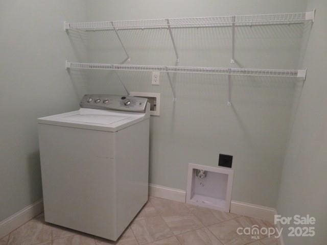 laundry area with laundry area, washer / clothes dryer, and baseboards