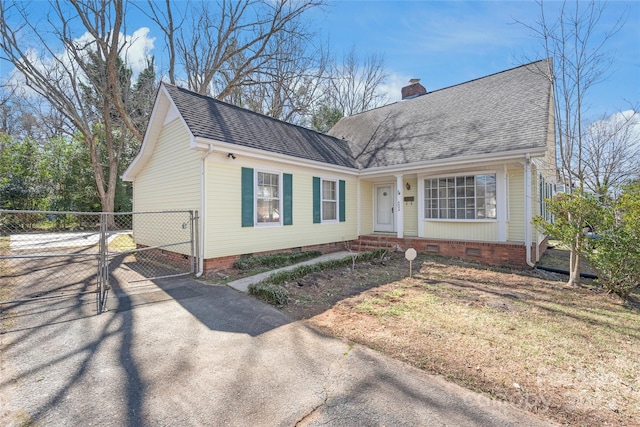 view of front of house featuring a gate, a shingled roof, a chimney, crawl space, and aphalt driveway