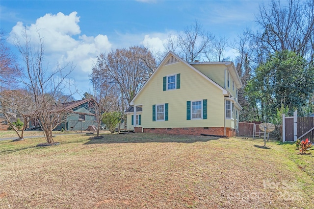 exterior space with a gate, a yard, fence, and crawl space