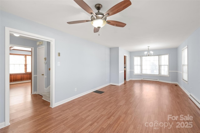 unfurnished room featuring a baseboard heating unit, light wood finished floors, plenty of natural light, and baseboard heating