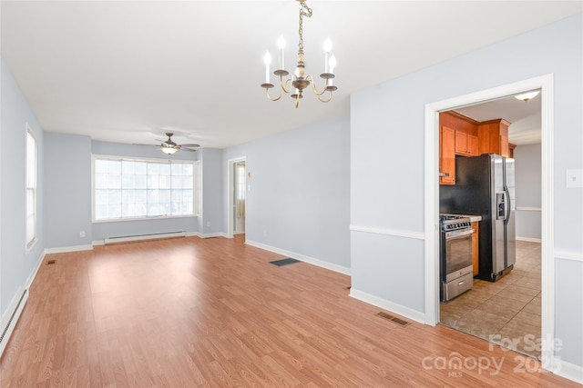 interior space featuring light wood finished floors, visible vents, baseboard heating, and a baseboard heating unit