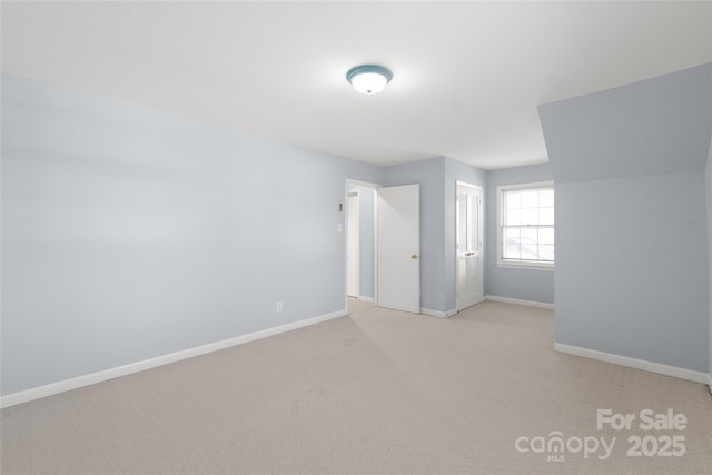 unfurnished bedroom with baseboards, a closet, and light carpet