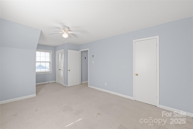 unfurnished bedroom featuring baseboards, carpet floors, and ceiling fan