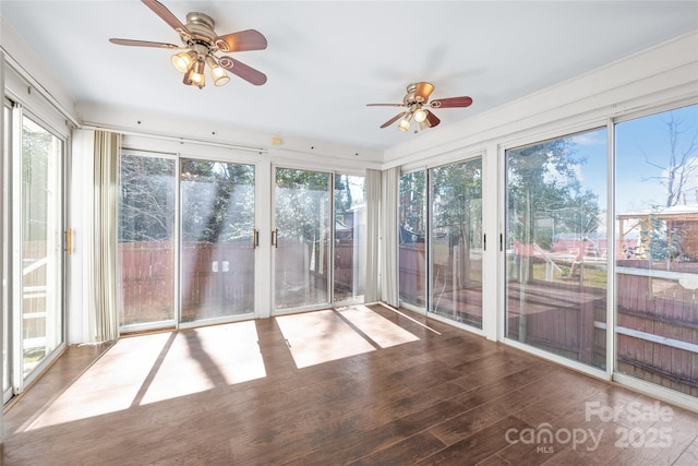 unfurnished sunroom featuring a wealth of natural light and ceiling fan