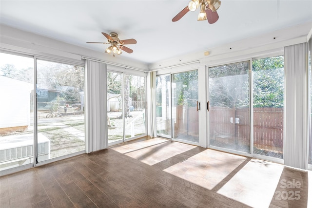 unfurnished sunroom featuring a ceiling fan