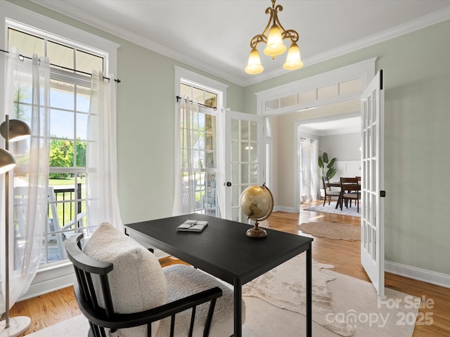 office space with french doors, light wood-style flooring, crown molding, and a chandelier