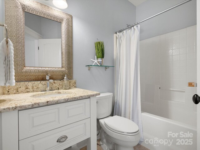 bathroom with vanity, shower / bath combo, and toilet