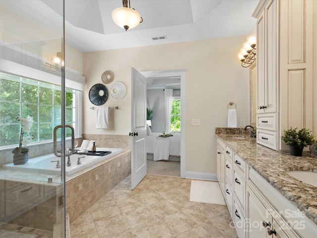 ensuite bathroom featuring a garden tub, double vanity, visible vents, connected bathroom, and tile patterned floors