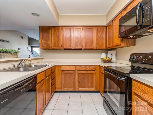 kitchen featuring black appliances, a sink, and brown cabinets