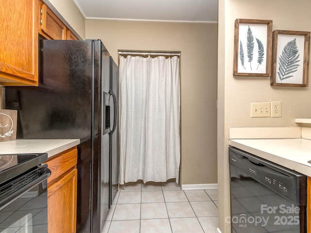 kitchen featuring light tile patterned floors, light countertops, ornamental molding, brown cabinets, and dishwasher