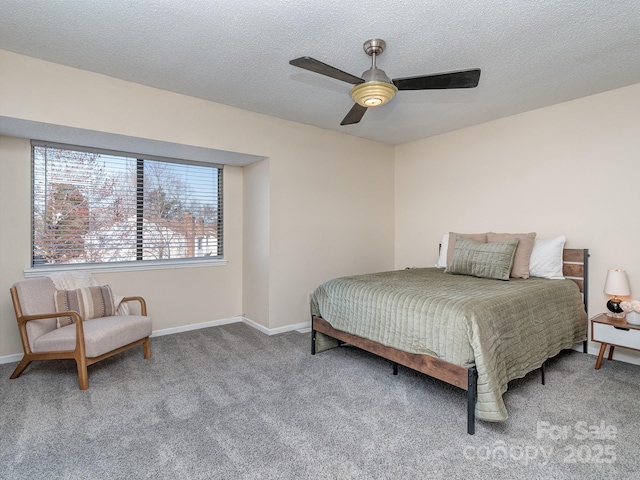 carpeted bedroom with a textured ceiling, ceiling fan, and baseboards