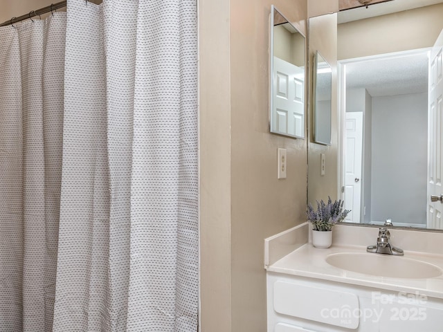 bathroom with a sink and a textured ceiling