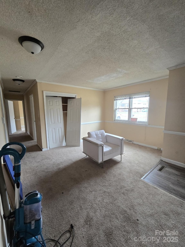 interior space with a closet, visible vents, carpet flooring, and crown molding