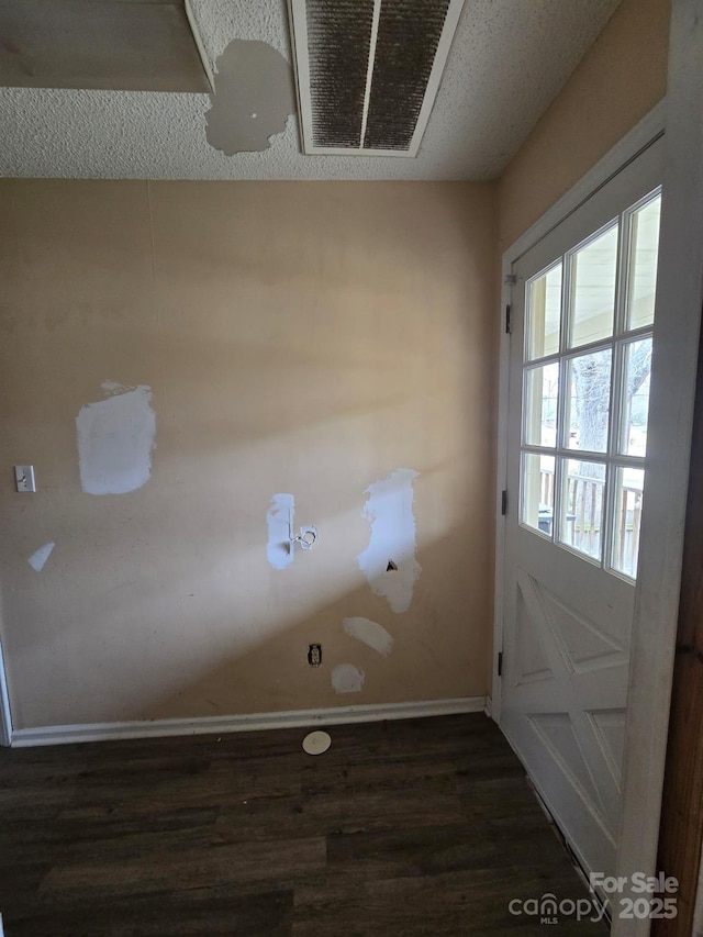 interior space with dark wood finished floors and baseboards