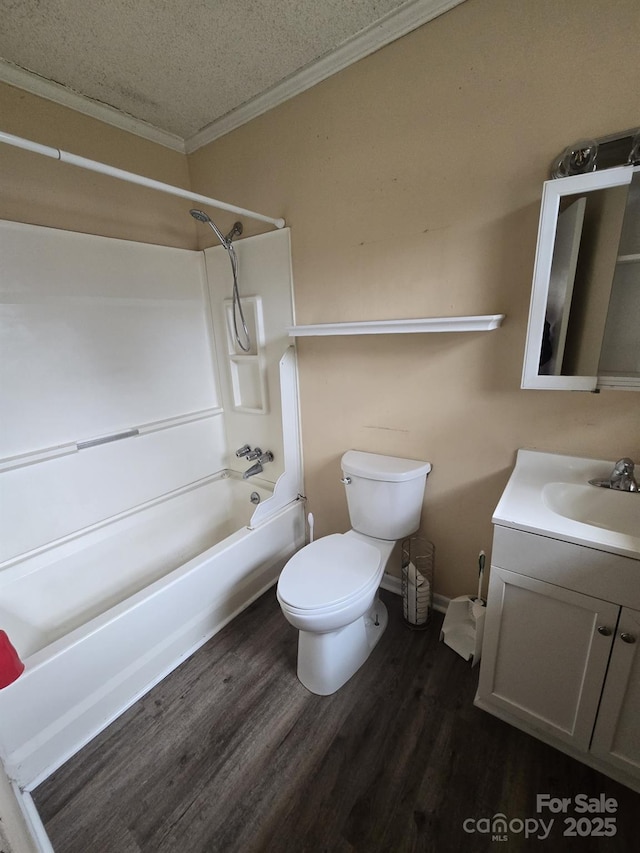 bathroom with toilet, ornamental molding, a textured ceiling, wood finished floors, and vanity