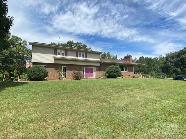 view of front facade with brick siding, a chimney, and a front lawn