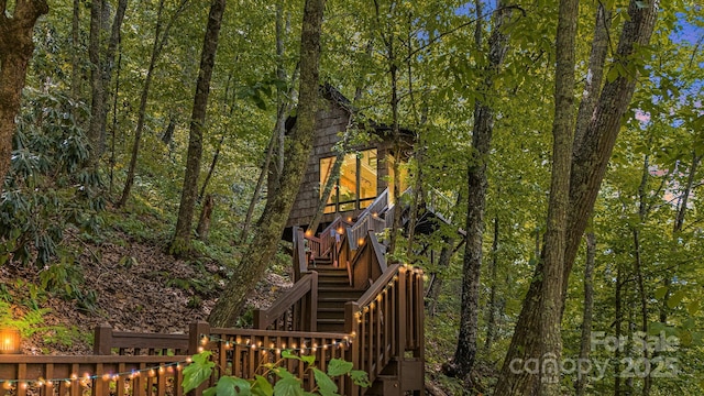 exterior space featuring stairway and a view of trees