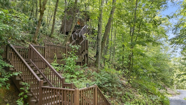 view of yard with a deck and stairs