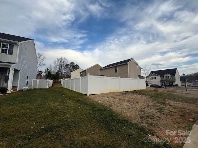 view of yard with a residential view and fence