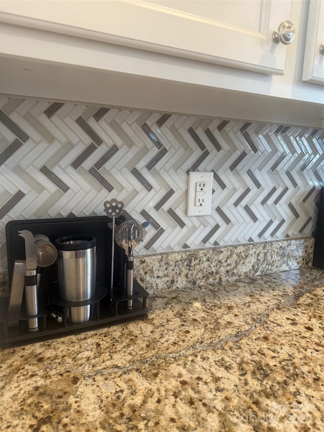 details with cooktop and white cabinets