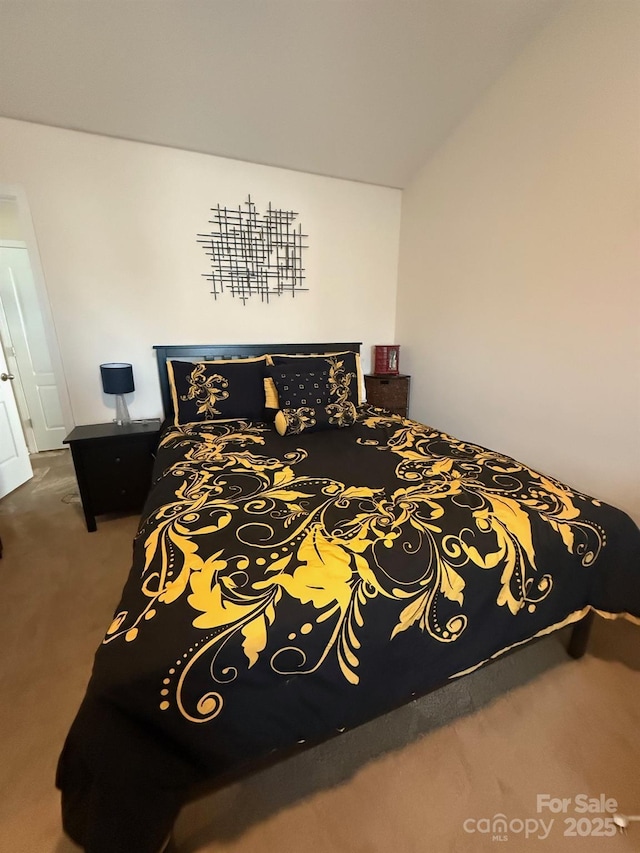 bedroom featuring vaulted ceiling and carpet flooring