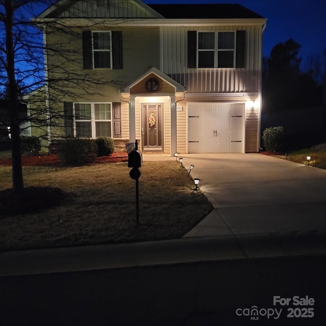 view of front of property with board and batten siding, driveway, and an attached garage