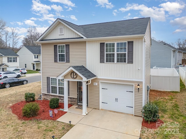 1301 Waylon Ave, Gastonia, NC 28054 - traditional-style home featuring a garage, fence, roof with shingles, concrete driveway, and stone siding