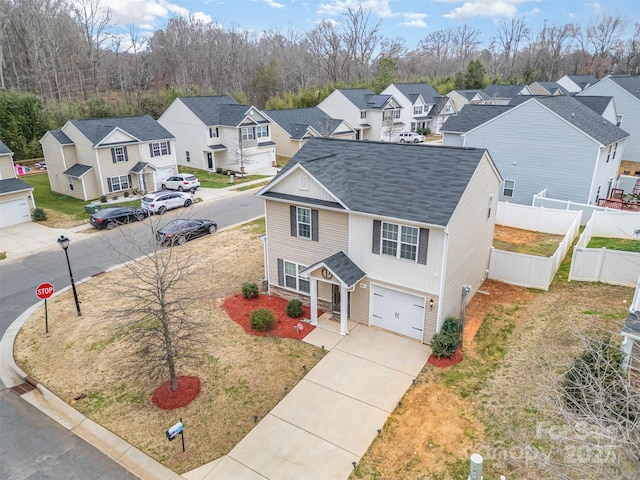 1301 Waylon Ave, Gastonia, NC 28054 - view of front of house with a residential view, a garage, a shingled roof, and concrete driveway