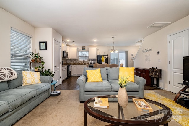 1301 Waylon Ave, Gastonia, NC 28054 - living room with a chandelier, dark wood-style floors, and recessed lighting