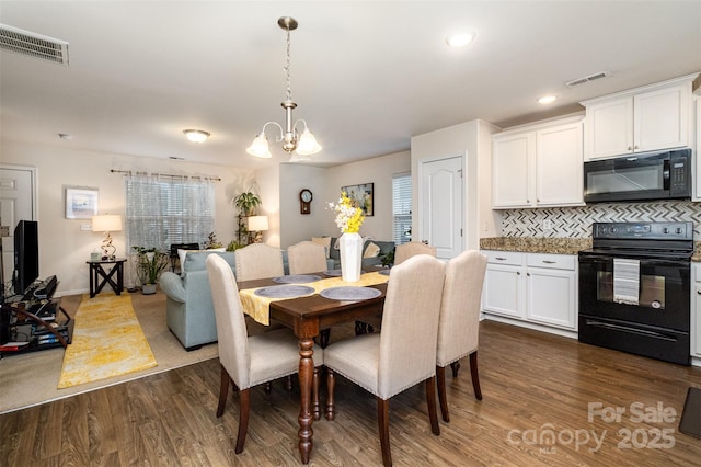 1301 Waylon Ave, Gastonia, NC 28054 - dining room featuring dark wood-style floors, a chandelier, recessed lighting, and baseboards