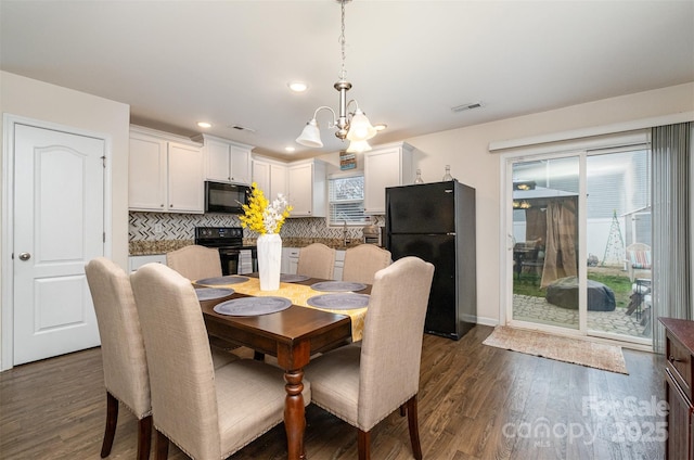 1301 Waylon Ave, Gastonia, NC 28054 - dining area featuring dark wood-type flooring, a chandelier, recessed lighting, and baseboards