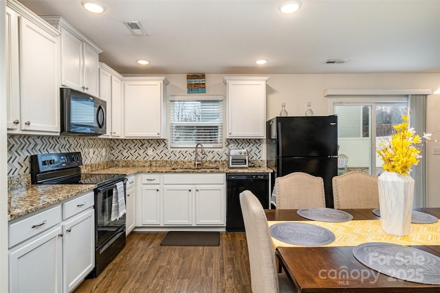 1301 Waylon Ave, Gastonia, NC 28054 - kitchen featuring black appliances, a sink, dark wood finished floors, white cabinetry, and tasteful backsplash