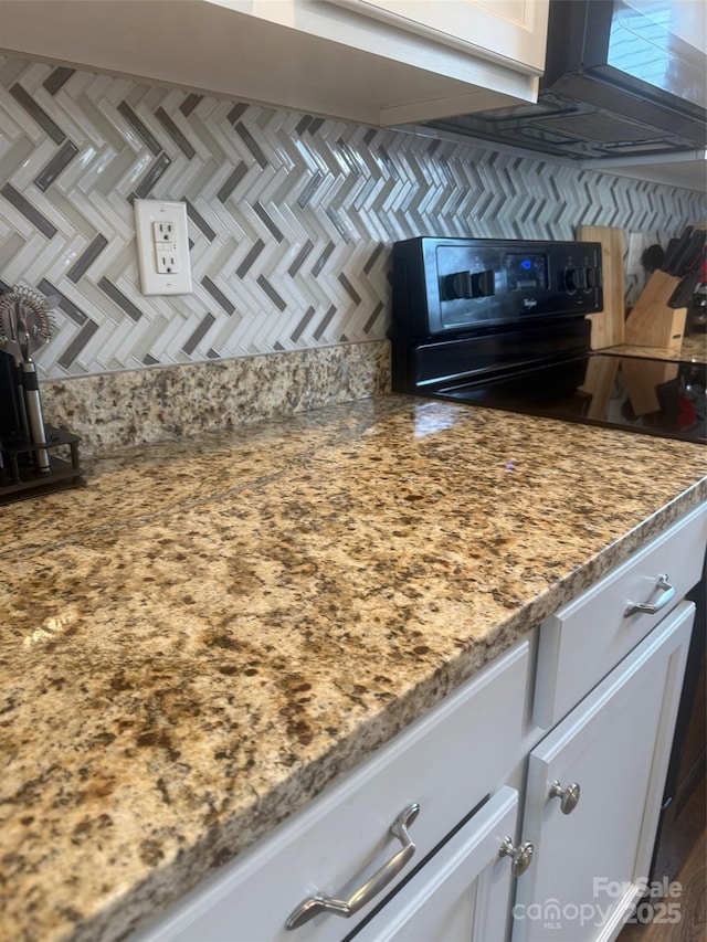 1301 Waylon Ave, Gastonia, NC 28054 - kitchen with range with electric cooktop, white cabinetry, tasteful backsplash, and light stone countertops