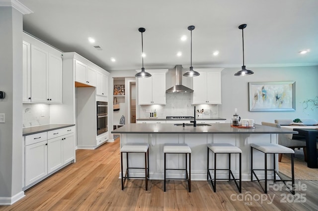 9843 Quercus Ln, Huntersville, NC 28078 - kitchen with wall chimney range hood, dark countertops, a sink, tasteful backsplash, and white cabinets