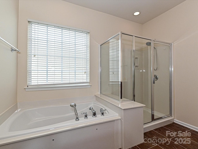 full bath featuring tile patterned floors, a stall shower, and a garden tub