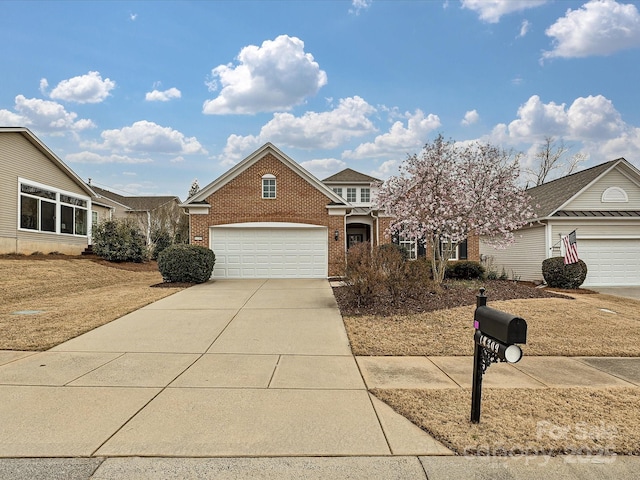 view of front facade featuring a garage, brick siding, and driveway