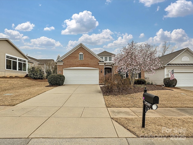 view of front of property with driveway, brick siding, and a garage