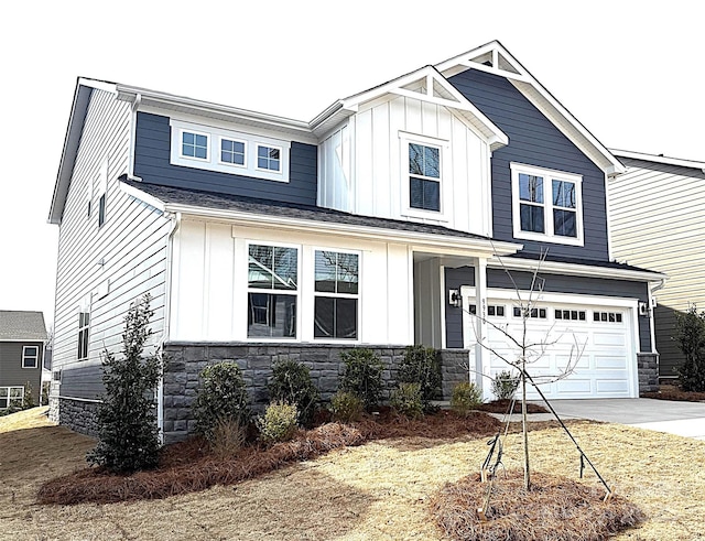 view of front of home featuring stone siding, board and batten siding, concrete driveway, and an attached garage