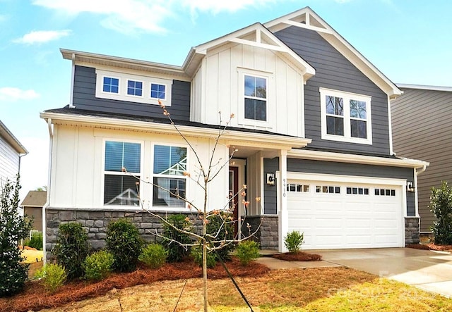 craftsman house with a garage, board and batten siding, driveway, and stone siding