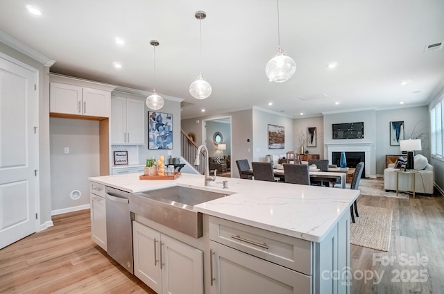 kitchen with stainless steel dishwasher, a sink, recessed lighting, and ornamental molding