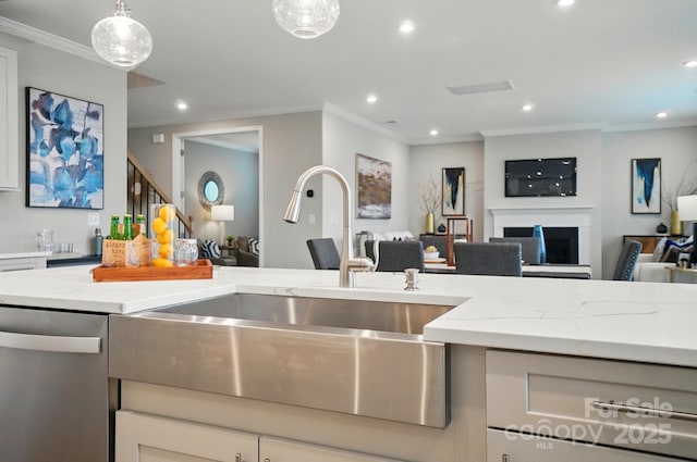 kitchen featuring light stone countertops, open floor plan, recessed lighting, a sink, and dishwasher