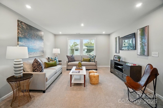 living room featuring baseboards, recessed lighting, and light colored carpet