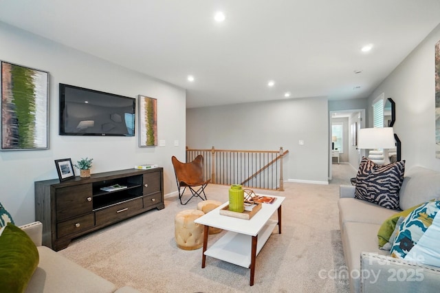 living room featuring recessed lighting, baseboards, and light carpet