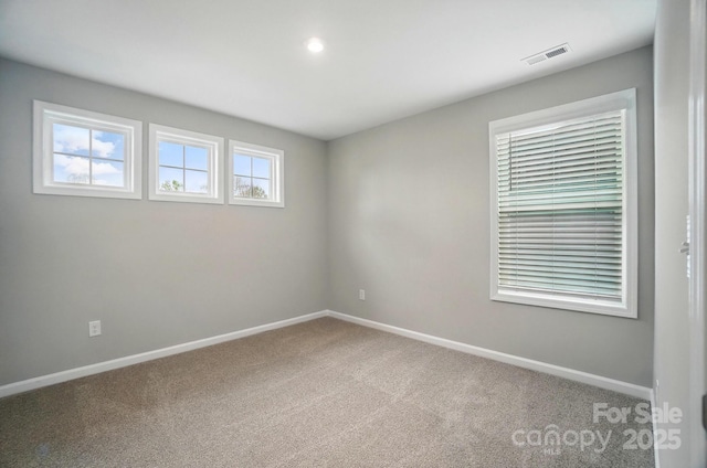 carpeted spare room with visible vents, recessed lighting, and baseboards