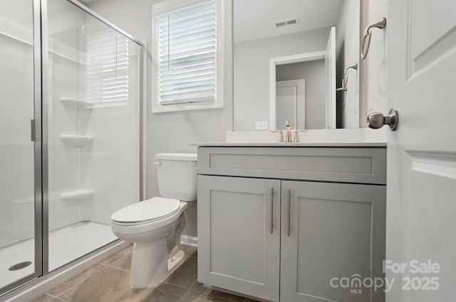 full bathroom featuring visible vents, a shower stall, vanity, tile patterned floors, and toilet