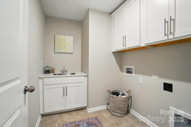 clothes washing area featuring cabinet space, washer hookup, a sink, electric dryer hookup, and baseboards