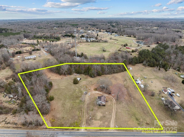 birds eye view of property with a rural view