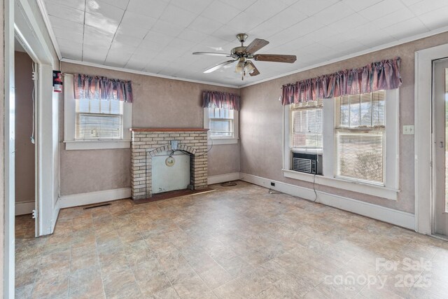 unfurnished living room featuring crown molding, a brick fireplace, and baseboards