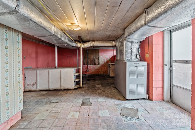 unfinished below grade area featuring heating unit and wood ceiling